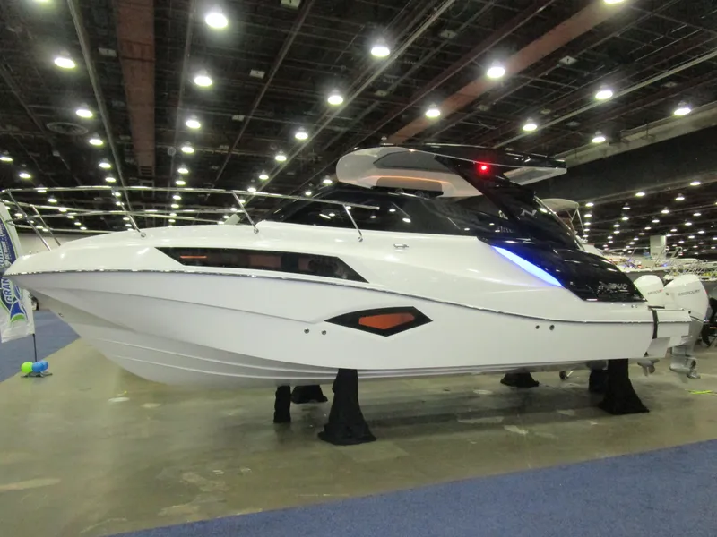The Image of 2025 NX Boats 340 Sport Coupe displayed at an indoor boat show. - 1