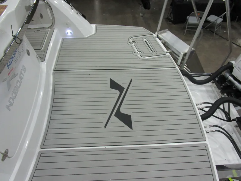 Slide: The Image of 2025 NX Boats 340 Sport Coupe deck with sleek design and logo. - 10
