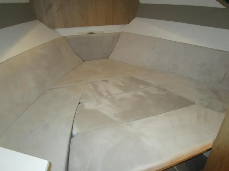 Slide: The Image of Interior cabin of 2025 NX Boats 340 Sport Coupe with beige upholstery. - 22