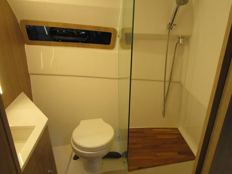 Slide: The Image of 2025 NX Boats 340 Sport Coupe bathroom with modern shower and toilet design. - 27