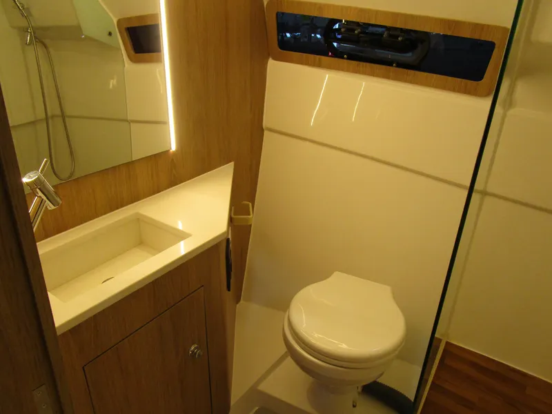 Slide: The Image of 2025 NX Boats 340 Sport Coupe bathroom with modern sink and toilet design. - 29