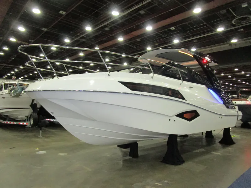 Slide: The Image of 2025 NX Boats 340 Sport Coupe displayed indoors, showcasing sleek design and modern features. - 3