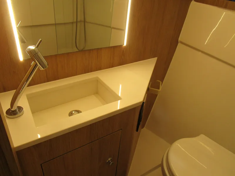 Slide: The Image of Luxurious bathroom in 2025 NX Boats 340 Sport Coupe with modern fixtures and elegant design. - 30