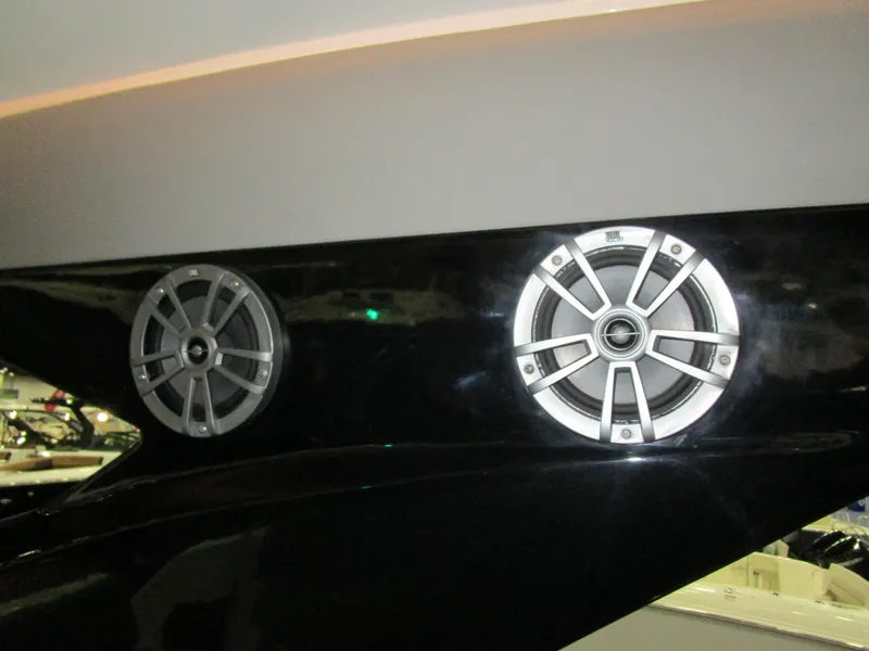 Slide: The Image of 2025 NX Boats 340 Sport Coupe speakers on sleek black exterior. - 32