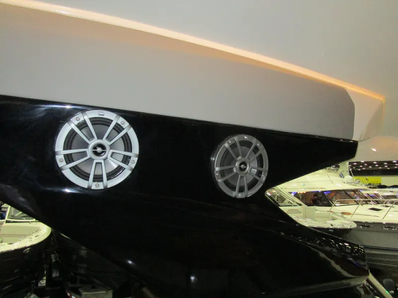 Slide: The Image of 2025 NX Boats 340 Sport Coupe with sleek black exterior and modern speaker design. - 33