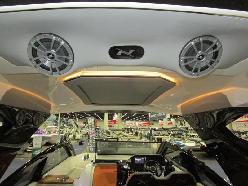 Slide: The Image of 2025 NX Boats 340 Sport Coupe interior with modern speakers and sleek design. - 34