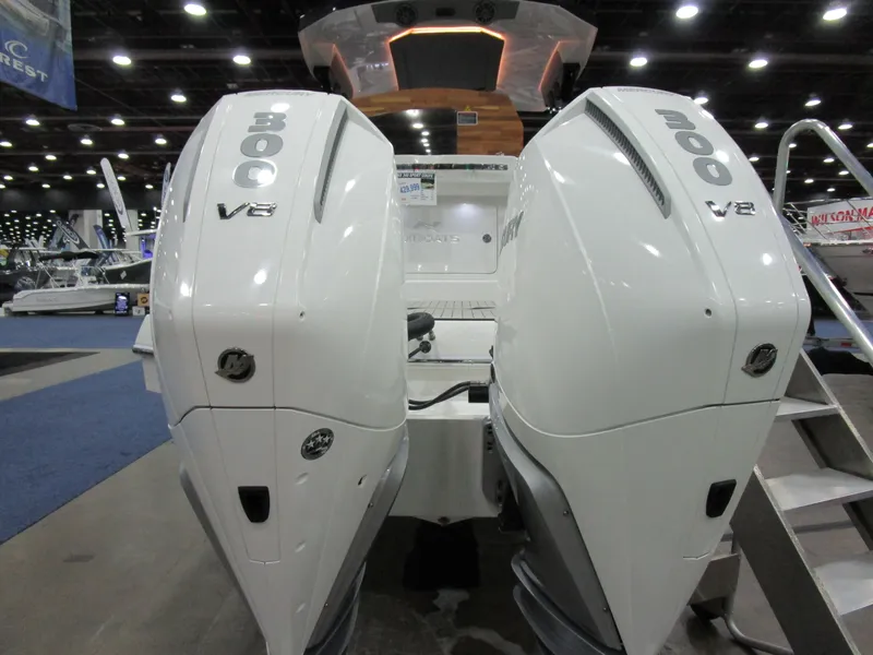 Slide: The Image of 2025 NX Boats 340 Sport Coupe with dual 300 V8 engines at a boat show. - 6