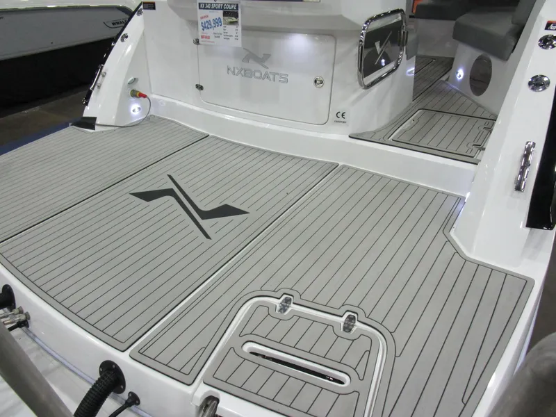 Slide: The Image of 2025 NX Boats 340 Sport Coupe deck with sleek design and modern features. - 7