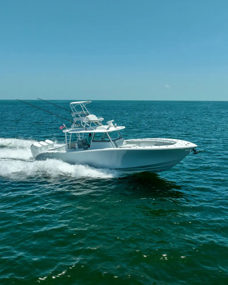 Slide: The Image of 2023 Yellowfin 42 Offshore boat cruising on open sea under clear blue sky. - 20