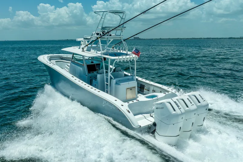 Slide: The Image of 2023 Yellowfin 42 Offshore boat cruising on open water, featuring triple outboard engines. - 21