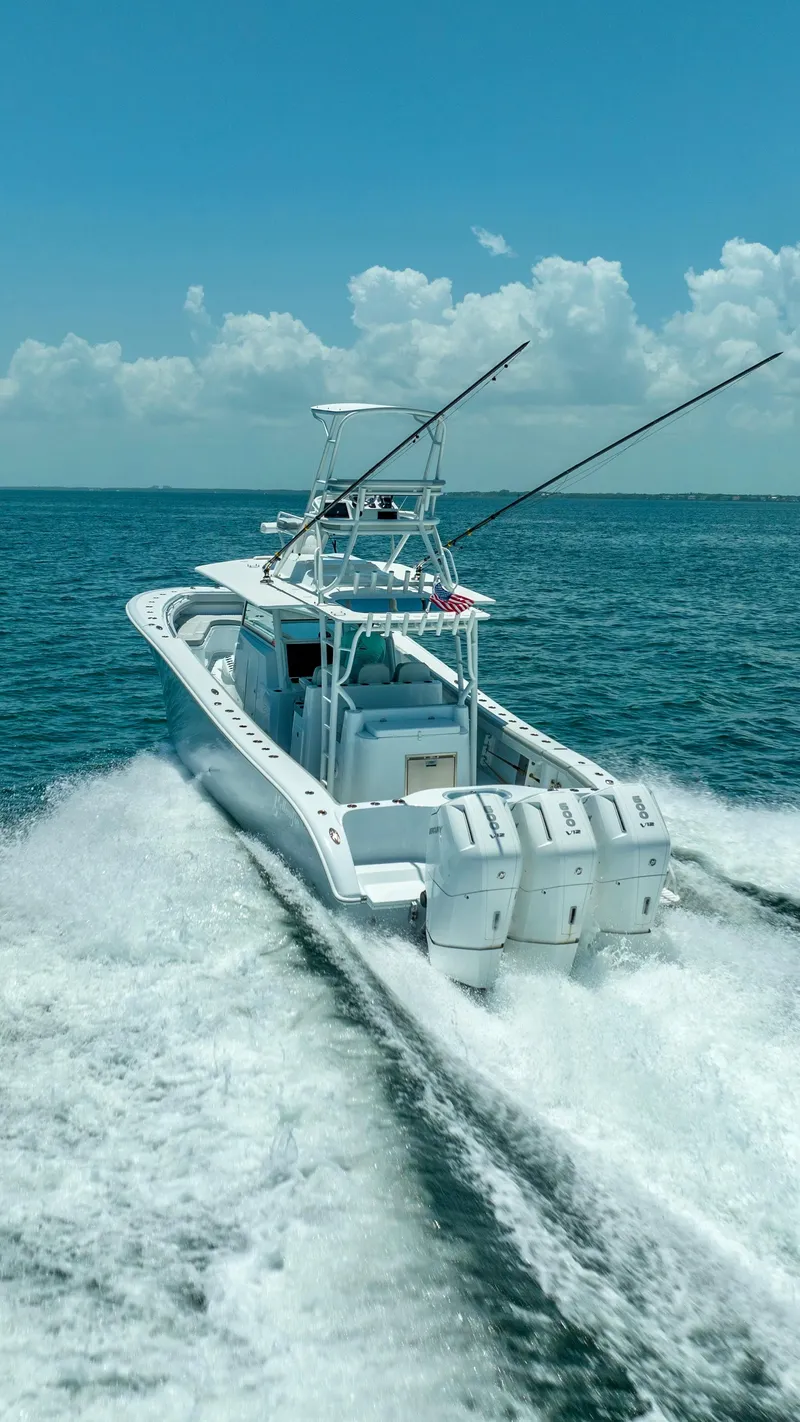Slide: The Image of 2023 Yellowfin 42 Offshore boat cruising on open ocean under clear blue sky. - 22