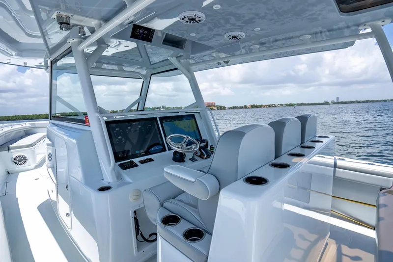 Slide: The Image of 2023 Yellowfin 42 Offshore boat interior with advanced navigation system and seating on open water. - 28