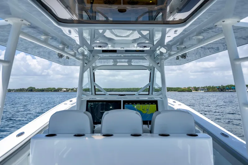 Slide: The Image of 2023 Yellowfin 42 Offshore boat interior with navigation screens on open water. - 29