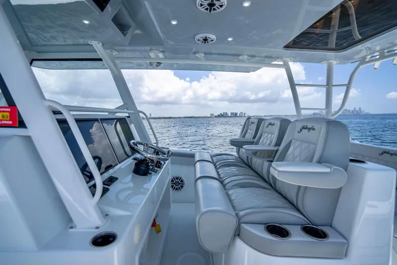 Slide: The Image of 2023 Yellowfin 42 Offshore boat interior with luxurious seating and ocean view. - 30
