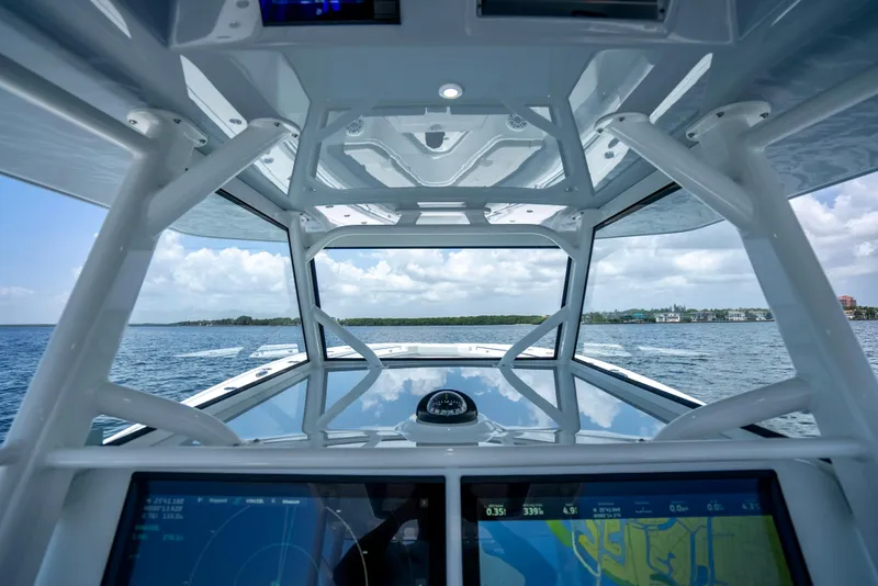 Slide: The Image of 2023 Yellowfin 42 Offshore boat interior with navigation screens and ocean view. - 31
