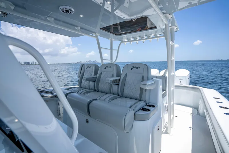 Slide: The Image of 2023 Yellowfin 42 Offshore boat interior with luxurious seating on open water. - 32