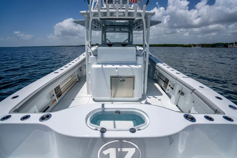 Slide: The Image of 2023 Yellowfin 42 Offshore boat on open water, showcasing spacious deck and sleek design. - 33