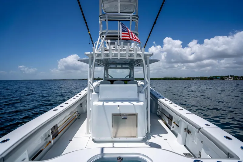 Slide: The Image of 2023 Yellowfin 42 Offshore boat on open water, featuring a sleek design and American flag. - 34