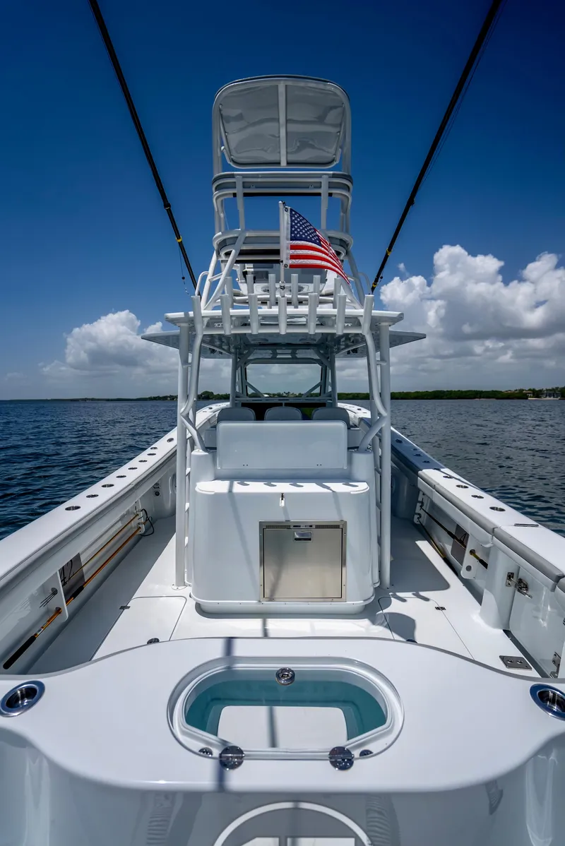 Slide: The Image of 2023 Yellowfin 42 Offshore boat on open water, featuring sleek design and American flag. - 35