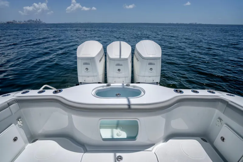 Slide: The Image of 2023 Yellowfin 42 Offshore boat with triple engines on open water. - 37