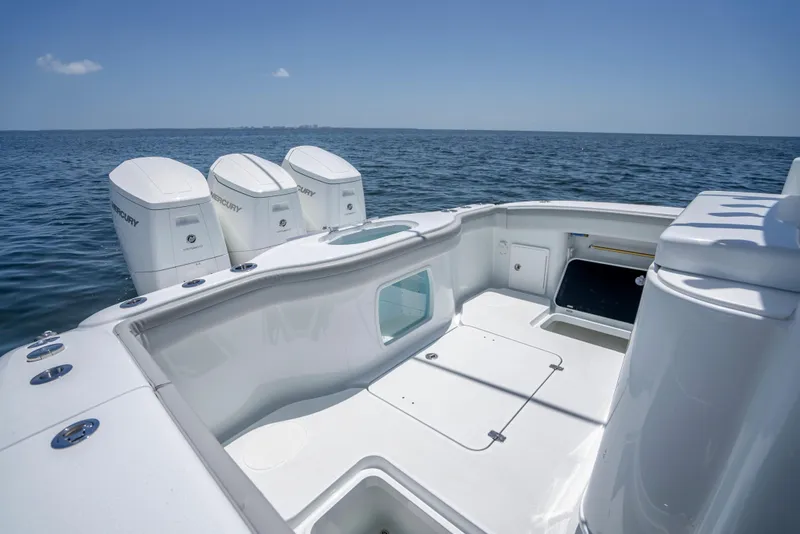 Slide: The Image of 2023 Yellowfin 42 Offshore boat with triple outboard engines on open sea. - 38