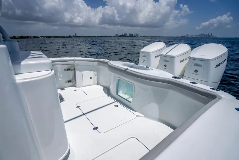 Slide: The Image of 2023 Yellowfin 42 Offshore boat with triple Mercury engines on open water. - 39
