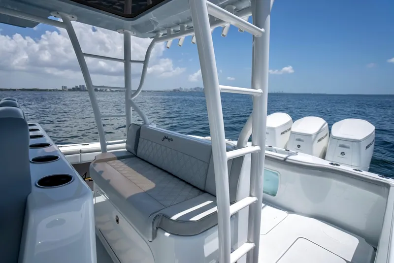 Slide: The Image of 2023 Yellowfin 42 Offshore boat interior with seating and ocean view. - 42