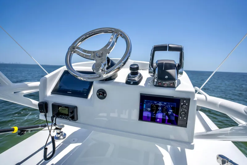 Slide: The Image of 2023 Yellowfin 42 Offshore boat helm with modern controls and ocean view. - 47
