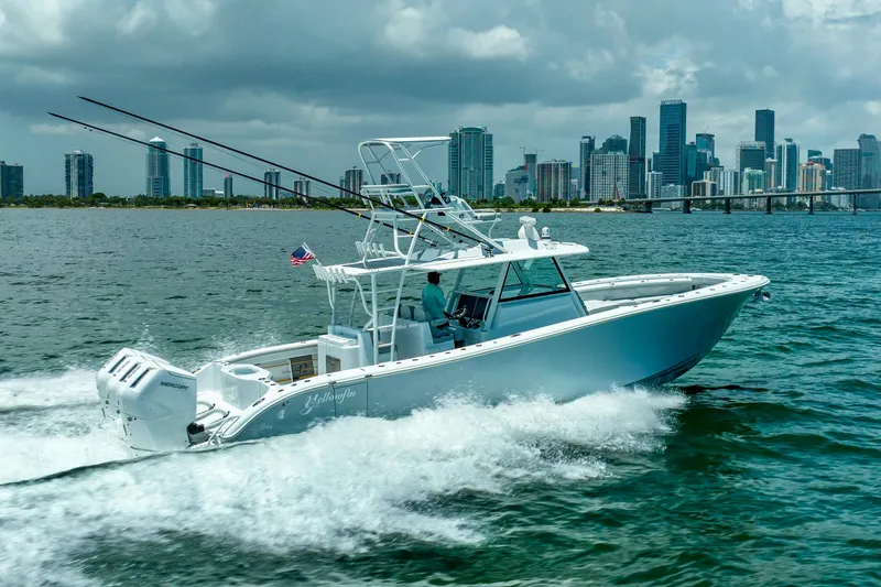 Slide: The Image of 2023 Yellowfin 42 Offshore boat cruising near city skyline on a sunny day. - 5