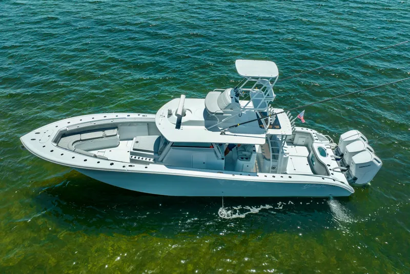 Slide: The Image of 2023 Yellowfin 42 Offshore boat on clear blue water, side view. - 8