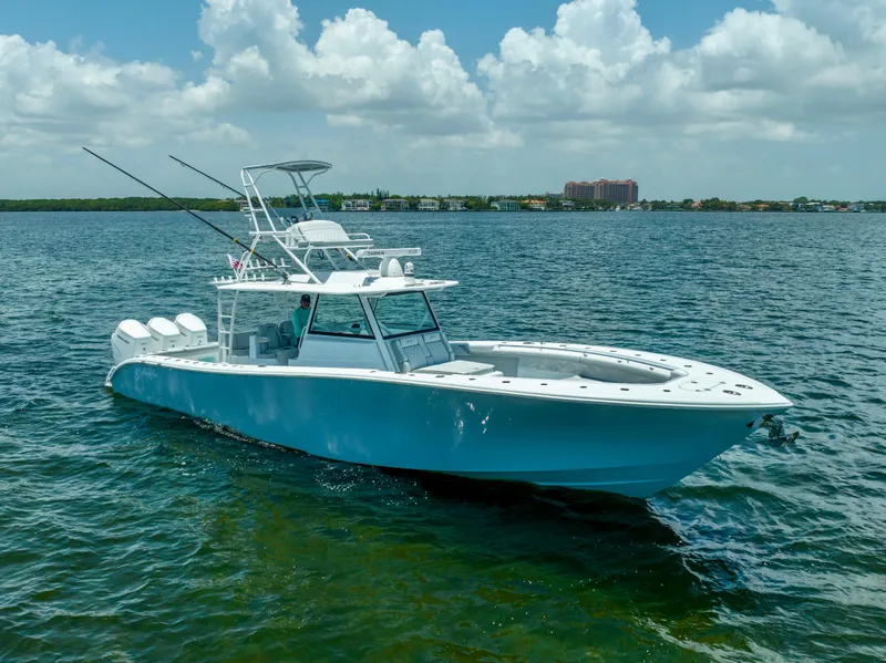 Slide: The Image of 2023 Yellowfin 42 Offshore boat on calm water under a partly cloudy sky. - 9