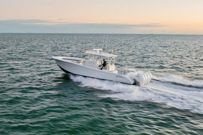 Slide: The Image of 2016 Yellowfin 39 Offshore boat cruising on open water at sunset. - 12