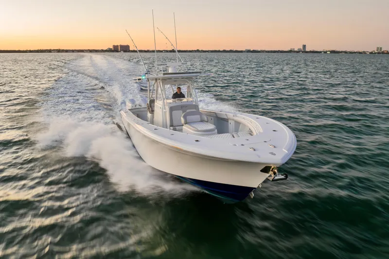 Slide: The Image of 2016 Yellowfin 39 Offshore boat cruising on open water at sunset. - 13