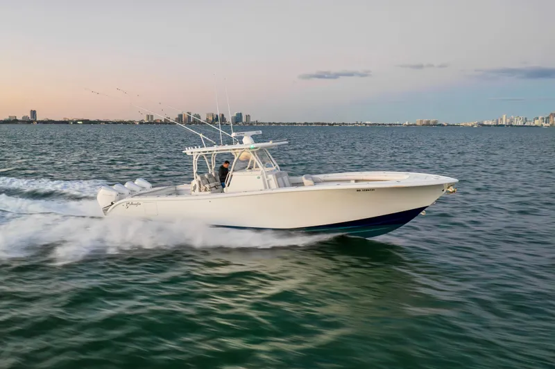 Slide: The Image of 2016 Yellowfin 39 Offshore boat cruising on open water at sunset. - 14