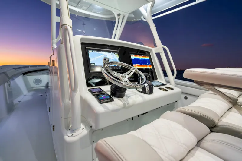 Slide: The Image of 2016 Yellowfin 39 Offshore boat console at sunset, featuring advanced navigation displays. - 19