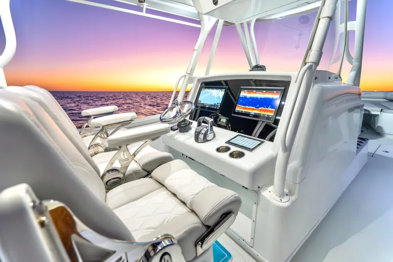 Slide: The Image of 2016 Yellowfin 39 Offshore boat cockpit with advanced navigation systems at sunset. - 20