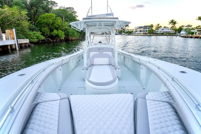 Slide: The Image of 2016 Yellowfin 39 Offshore boat with luxurious seating on a serene waterway. - 22