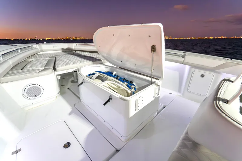 Slide: The Image of 2016 Yellowfin 39 Offshore boat deck with open storage compartment at sunset. - 29