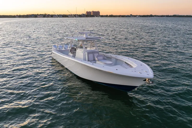 Slide: The Image of 2016 Yellowfin 39 Offshore boat on calm water at sunset. - 3