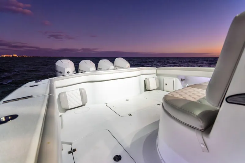 Slide: The Image of 2016 Yellowfin 39 Offshore boat at sunset, featuring spacious deck and multiple engines. - 30