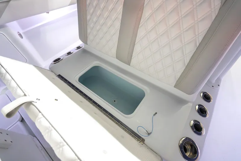 Slide: The Image of 2016 Yellowfin 39 Offshore boat interior with storage compartment and quilted seating. - 36