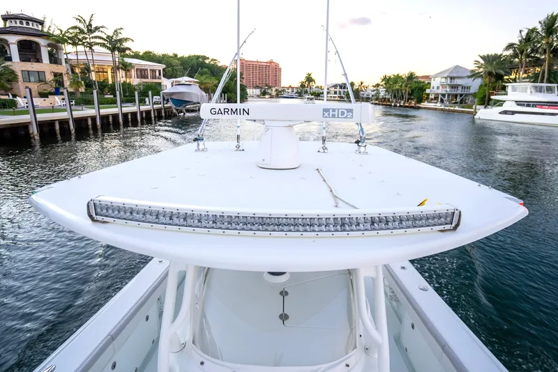 Slide: The Image of 2016 Yellowfin 39 Offshore boat with Garmin equipment, docked in a scenic waterfront area. - 37