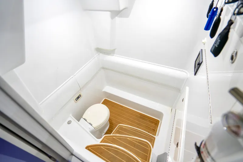 Slide: The Image of 2016 Yellowfin 39 Offshore boat bathroom with wooden flooring and white fixtures. - 40