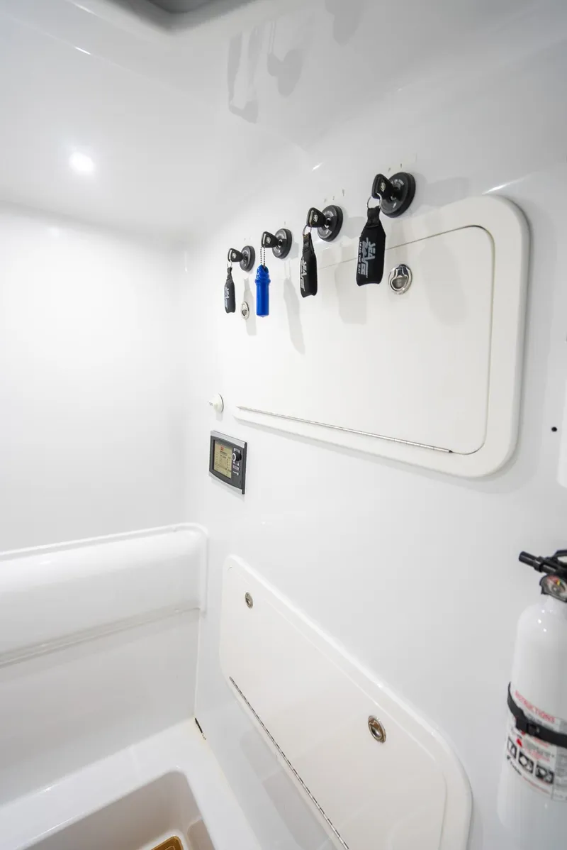 Slide: The Image of 2016 Yellowfin 39 Offshore interior with fishing rod holders and storage compartments. - 41