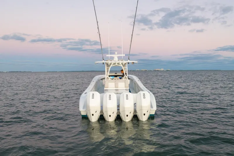 Slide: The Image of 2016 Yellowfin 39 Offshore boat with four engines on calm water at sunset. - 6