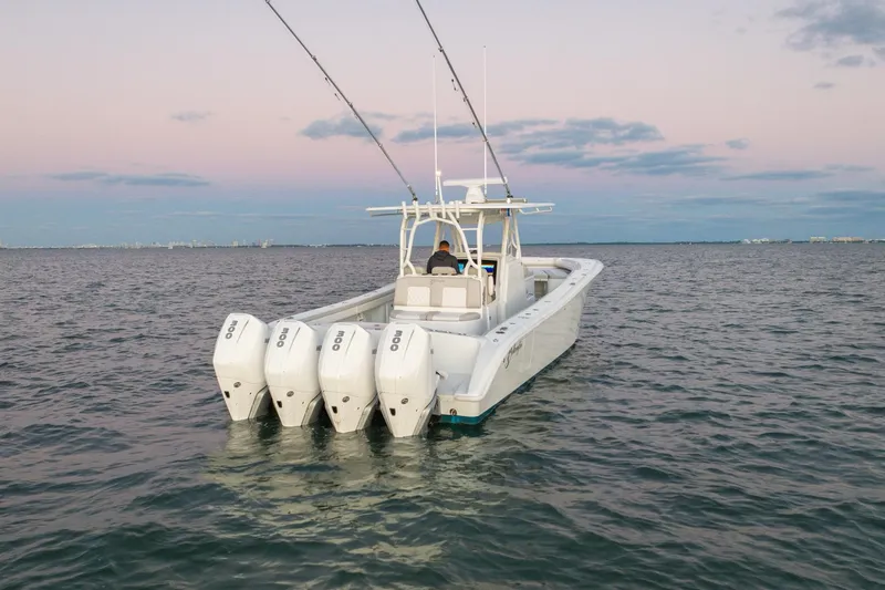 Slide: The Image of 2016 Yellowfin 39 Offshore boat with four engines on calm water at sunset. - 7