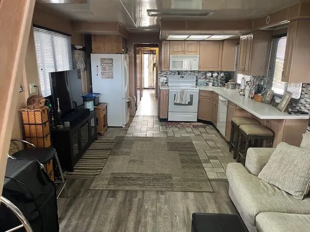 Slide: The Image of 1988 Stardust Cruisers houseboat interior with kitchen, living area, and modern appliances. - 3