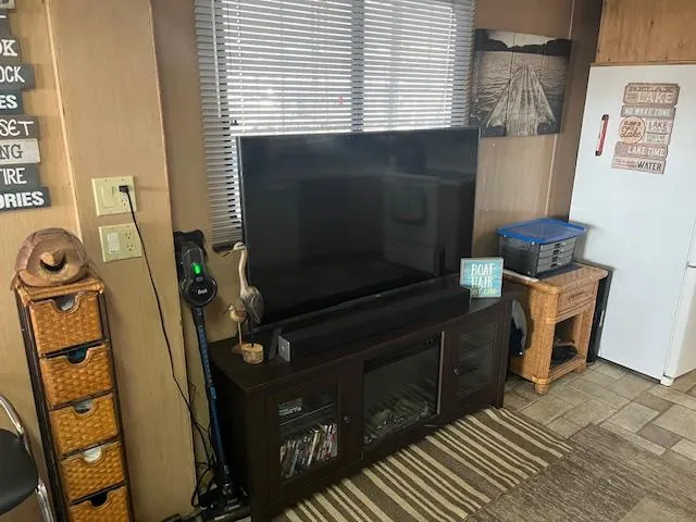 Slide: The Image of Living area in 1988 Stardust Cruisers houseboat with TV, wicker baskets, and decor. - 5