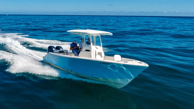 Slide: The Image of 2022 Cobia 240 CC boat cruising on open blue ocean waters. - 1