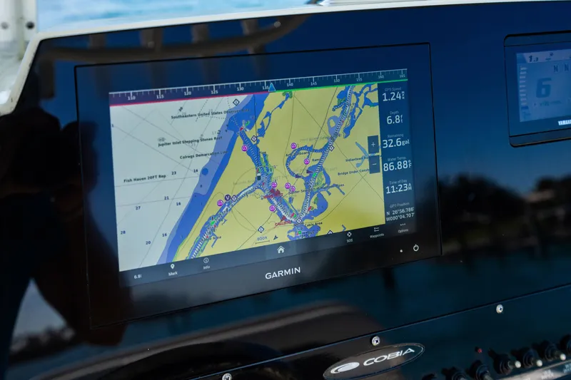 Slide: The Image of Garmin navigation display on 2022 Cobia 240 CC boat, showing detailed marine map. - 14